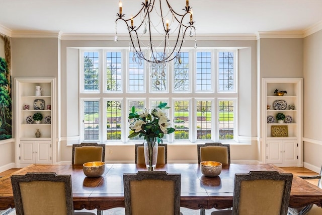 dining room with ornamental molding, light hardwood / wood-style floors, and a notable chandelier