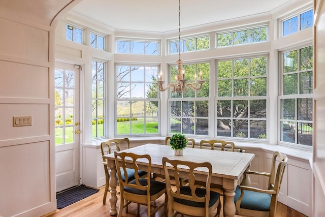 sunroom / solarium with a chandelier and plenty of natural light