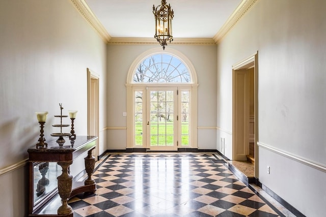 entryway featuring ornamental molding, tile floors, and a chandelier