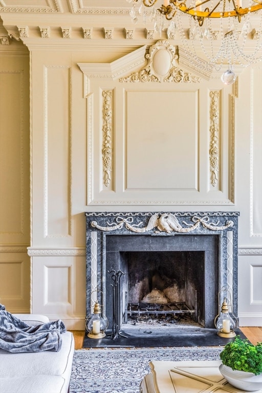 interior details with ornamental molding and hardwood / wood-style flooring