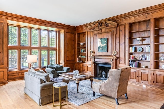 interior space with light hardwood / wood-style flooring, crown molding, and built in shelves