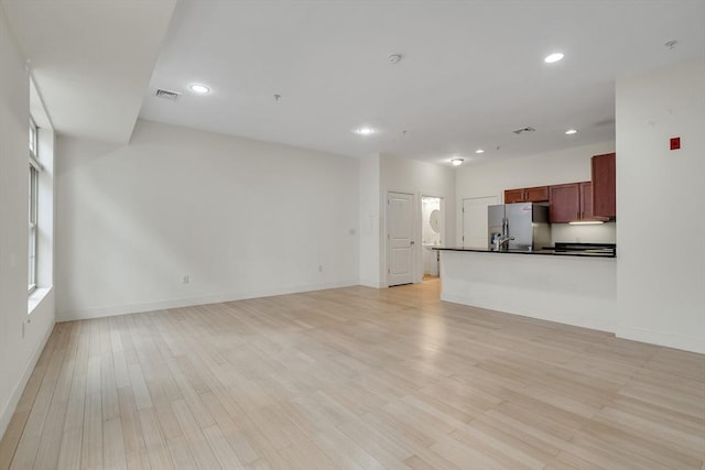 unfurnished living room with light wood-type flooring