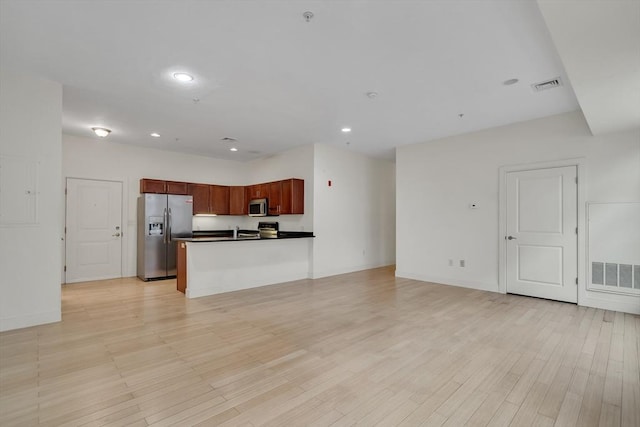 kitchen featuring light wood-type flooring and appliances with stainless steel finishes