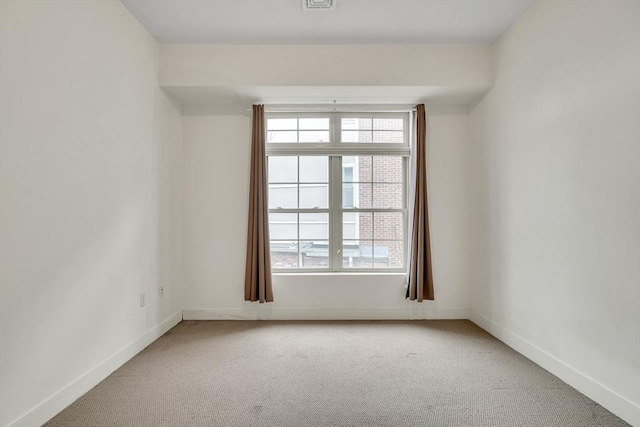 spare room with carpet floors and plenty of natural light