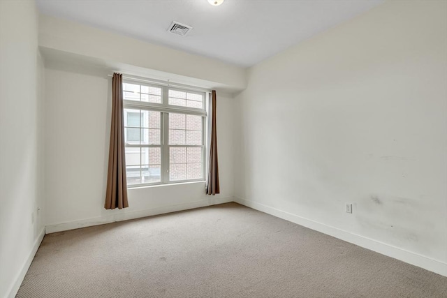 spare room featuring carpet and a healthy amount of sunlight