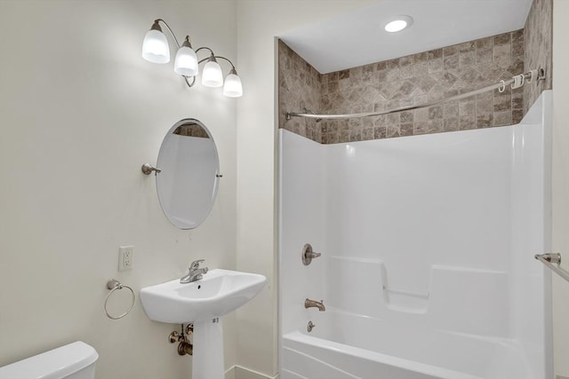 bathroom with bathing tub / shower combination and toilet