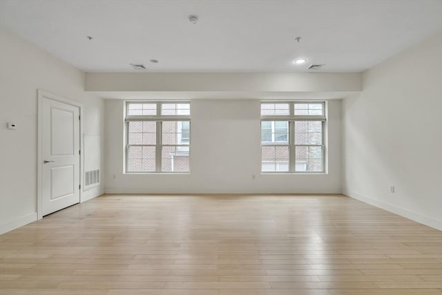 empty room with a healthy amount of sunlight and light wood-type flooring