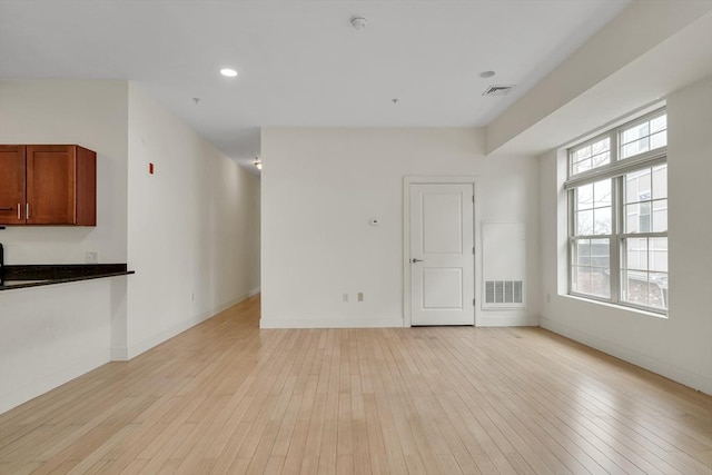 unfurnished living room with light hardwood / wood-style flooring