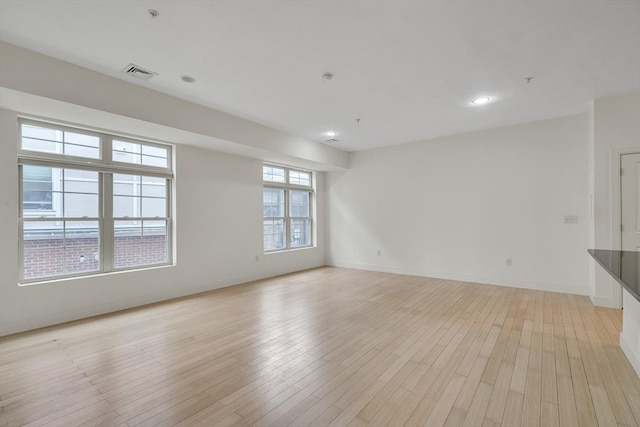 spare room featuring light hardwood / wood-style floors