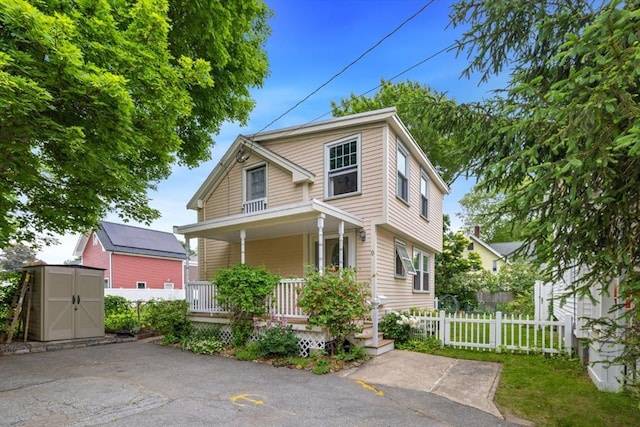 9 Emerson Ct, Winchester, MA 01890 - view of front facade featuring a storage unit and covered porch