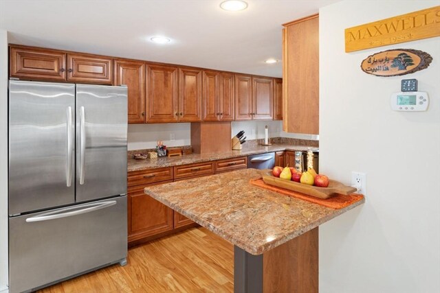 9 Emerson Ct, Winchester, MA 01890 - kitchen with appliances with stainless steel finishes, brown cabinets, recessed lighting, light stone countertops, and light wood-style floors