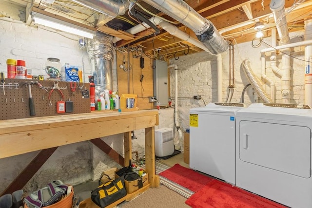 9 Emerson Ct, Winchester, MA 01890 - unfinished basement featuring washer and clothes dryer, electric panel, and a workshop area