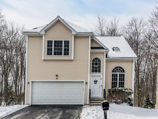 view of front facade with an attached garage and aphalt driveway