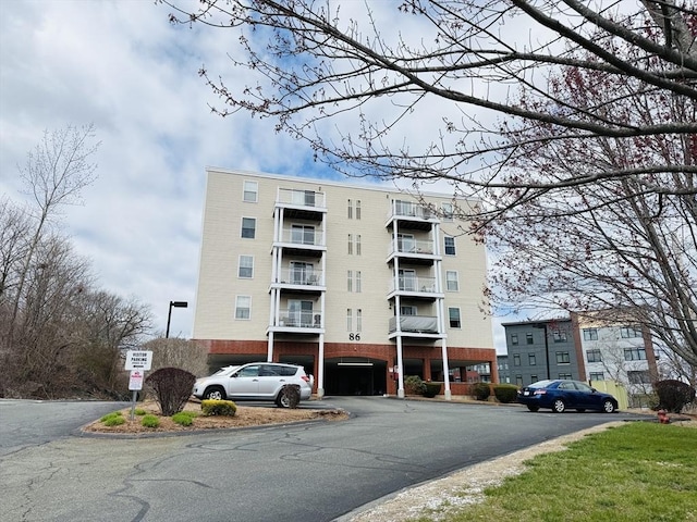 view of building exterior featuring uncovered parking