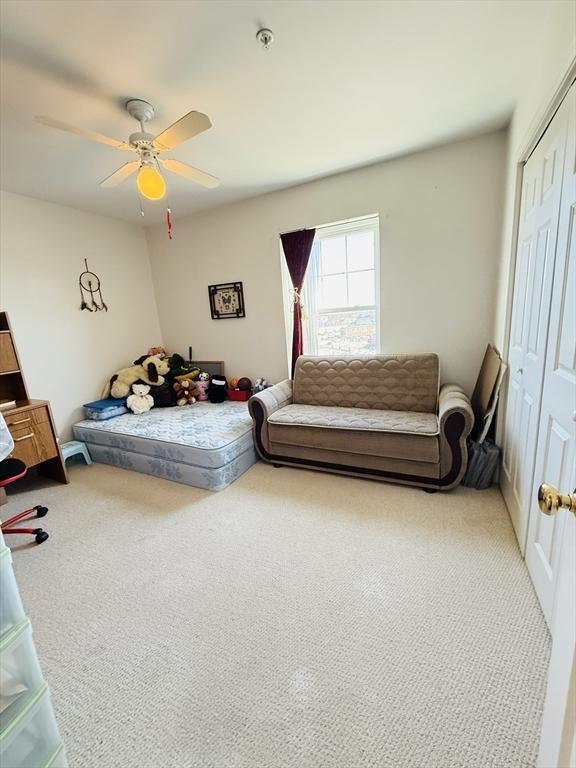 bedroom with a closet, carpet floors, and ceiling fan