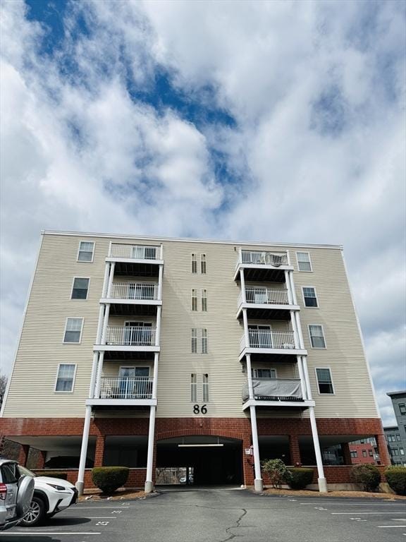 view of building exterior with uncovered parking