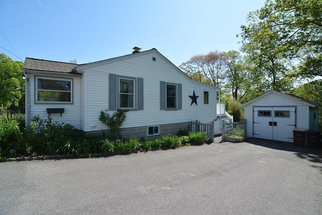 82 Circuit Ave, Weymouth, MA 02188 - view of side of home with a detached garage, an outbuilding, fence, and asphalt driveway
