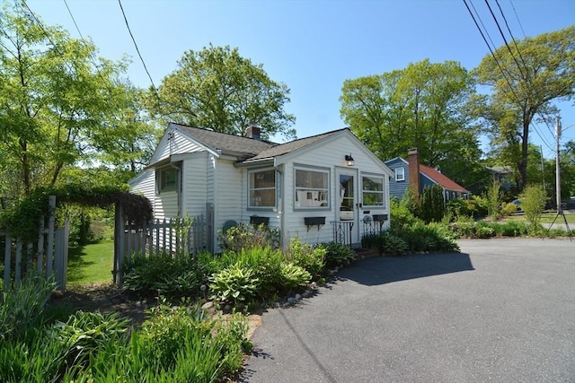 82 Circuit Ave, Weymouth, MA 02188 - view of home's exterior featuring a chimney and fence
