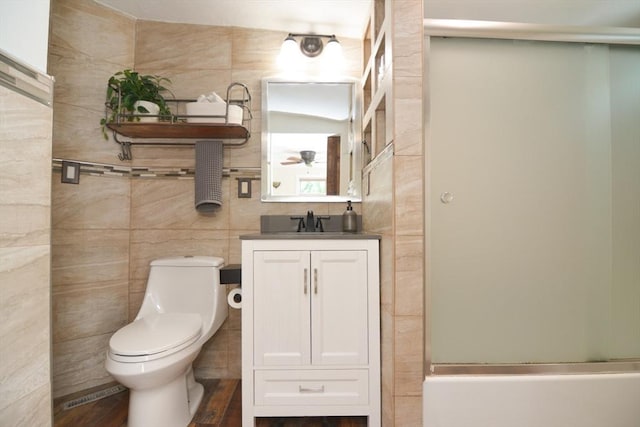82 Circuit Ave, Weymouth, MA 02188 - bathroom with toilet, vanity, and tile walls