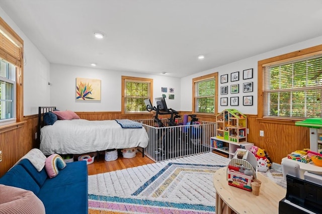 241 W Main St, Westborough, MA 01581 - bedroom with wainscoting, multiple windows, wooden walls, wood finished floors, and recessed lighting