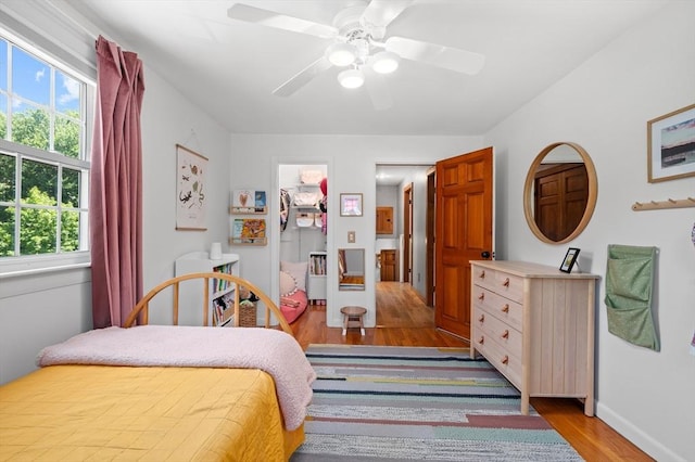 241 W Main St, Westborough, MA 01581 - bedroom featuring wood finished floors, multiple windows, a ceiling fan, and a spacious closet
