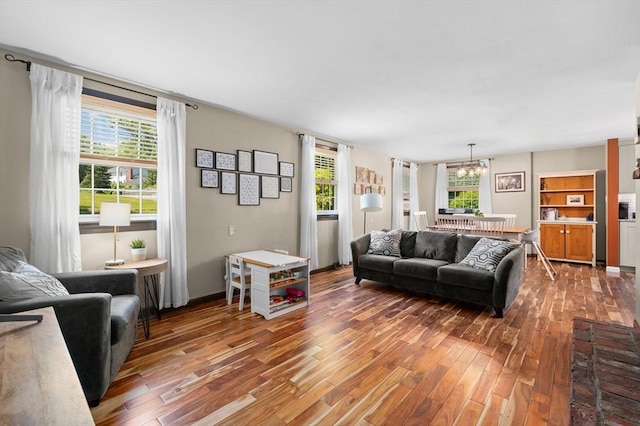 241 W Main St, Westborough, MA 01581 - living area featuring wood finished floors, a chandelier, and plenty of natural light