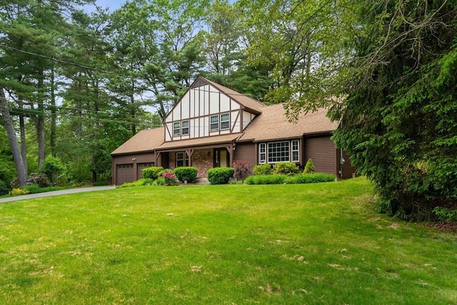 369 Border Rd, Concord, MA 01742 - tudor-style house featuring an attached garage, a front yard, driveway, and roof with shingles