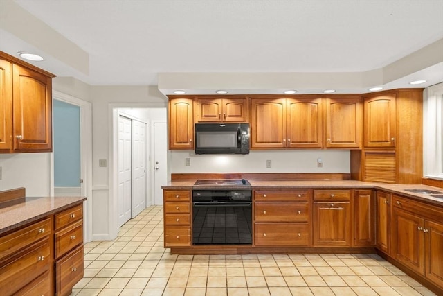369 Border Rd, Concord, MA 01742 - kitchen with black appliances, recessed lighting, light tile patterned floors, and brown cabinetry