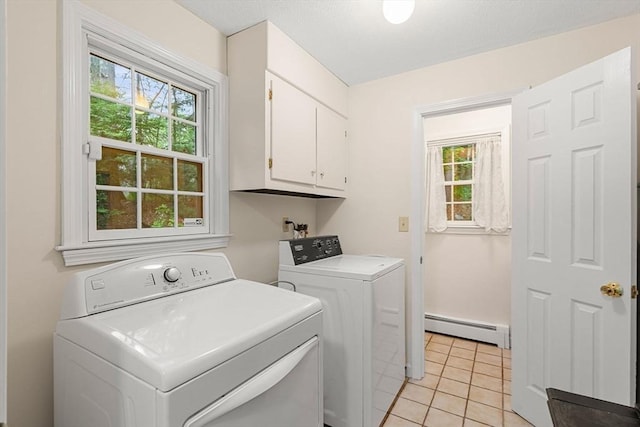369 Border Rd, Concord, MA 01742 - laundry room featuring a baseboard radiator, washing machine and dryer, cabinet space, and light tile patterned floors