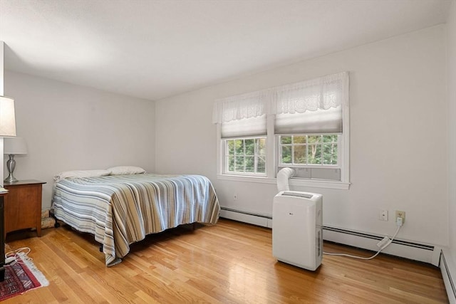 369 Border Rd, Concord, MA 01742 - bedroom with a baseboard heating unit and light wood-type flooring
