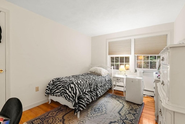 369 Border Rd, Concord, MA 01742 - bedroom with baseboard heating and light wood-style floors