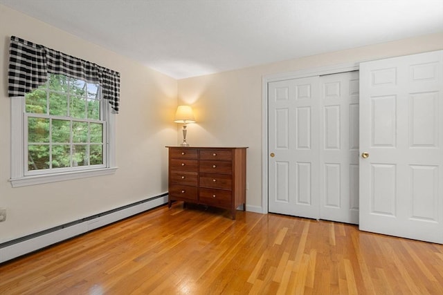 369 Border Rd, Concord, MA 01742 - bedroom featuring a baseboard radiator, light wood finished floors, and a closet