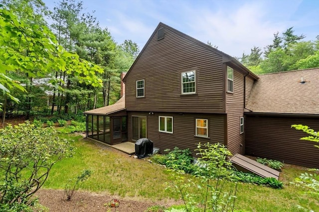 369 Border Rd, Concord, MA 01742 - rear view of house featuring a sunroom and roof with shingles
