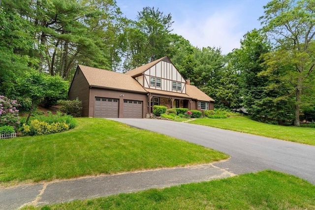 369 Border Rd, Concord, MA 01742 - english style home with an attached garage, driveway, and a front lawn
