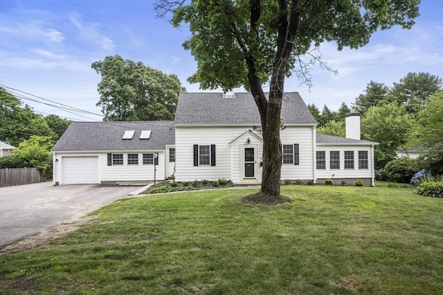 view of front of house with a garage and a front lawn