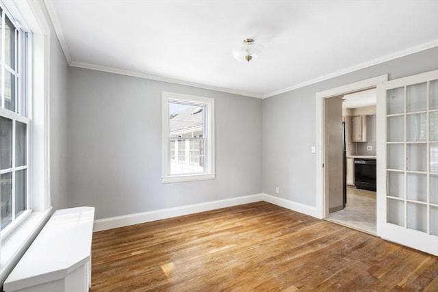 unfurnished room featuring ornamental molding and hardwood / wood-style flooring