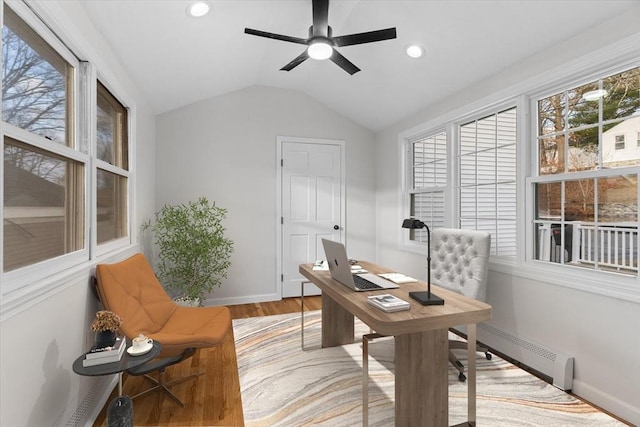 office area with ceiling fan, lofted ceiling, light hardwood / wood-style flooring, and a baseboard radiator