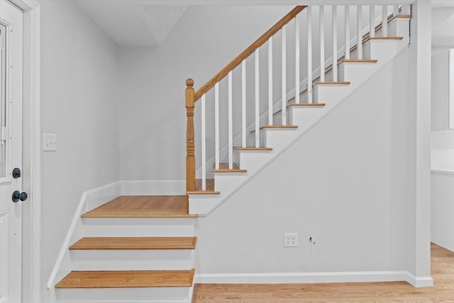 stairs featuring hardwood / wood-style floors