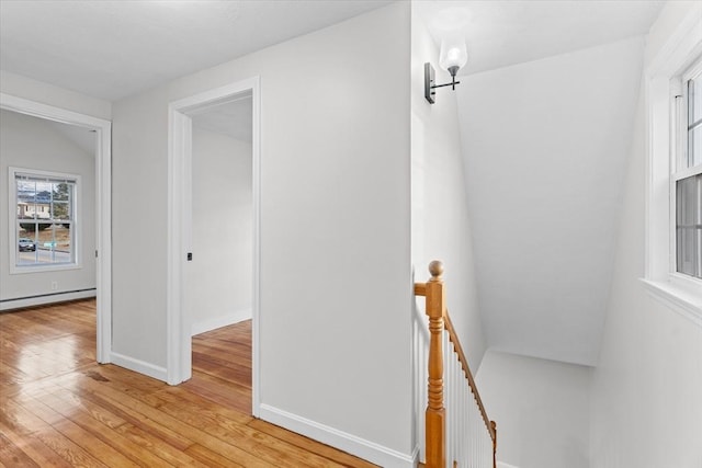 interior space featuring wood-type flooring and a baseboard heating unit