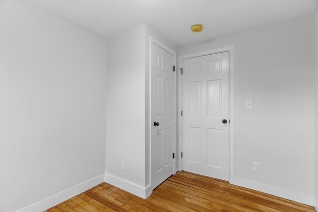 empty room with hardwood / wood-style flooring