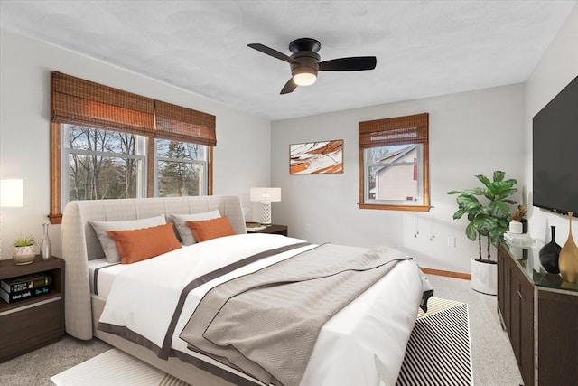 bedroom featuring ceiling fan and light carpet