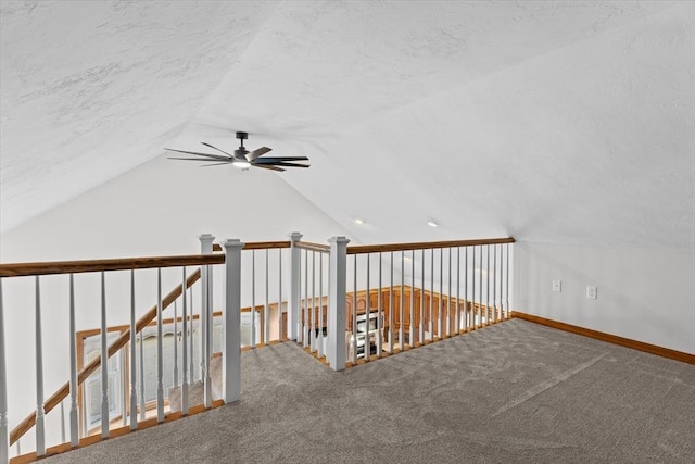 additional living space featuring carpet, ceiling fan, lofted ceiling, and a textured ceiling