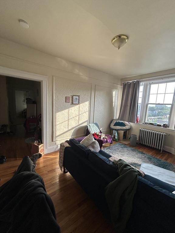 1691 Commonwealth Unit 32, Boston, MA 02135 - living area featuring radiator heating unit and wood finished floors