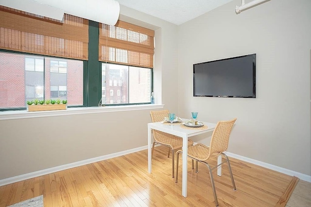 dining area featuring wood finished floors and baseboards