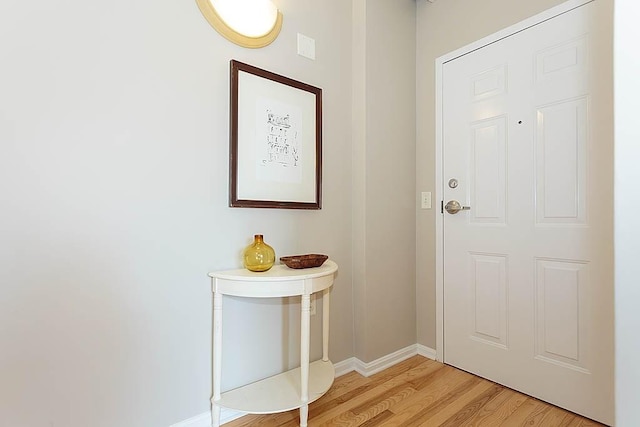 doorway featuring light wood-style floors and baseboards