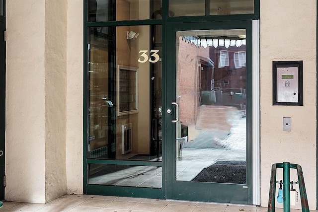 property entrance with stucco siding