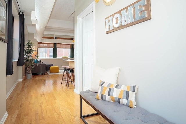 hallway with baseboards and wood finished floors