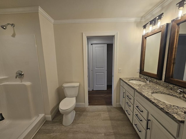 bathroom with ornamental molding, toilet, and vanity