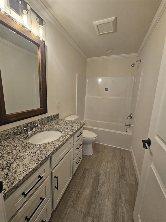 full bathroom with vanity, crown molding, bathing tub / shower combination, and toilet