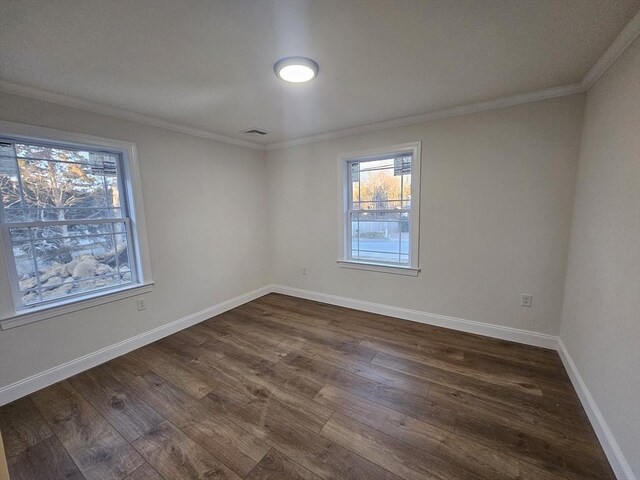 empty room featuring crown molding and dark hardwood / wood-style floors